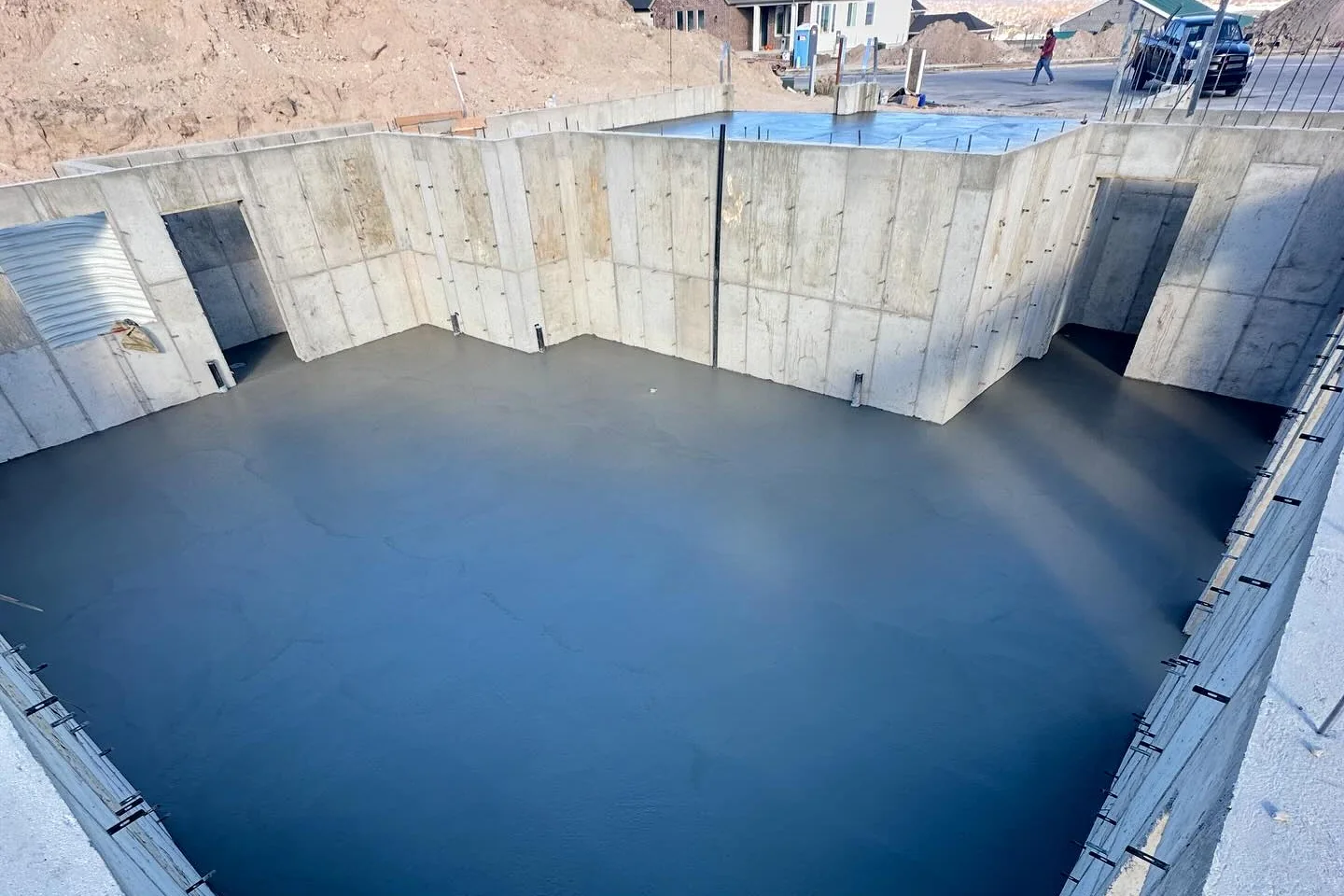Fresh slab inside tall concrete walls by MD Concrete in Utah